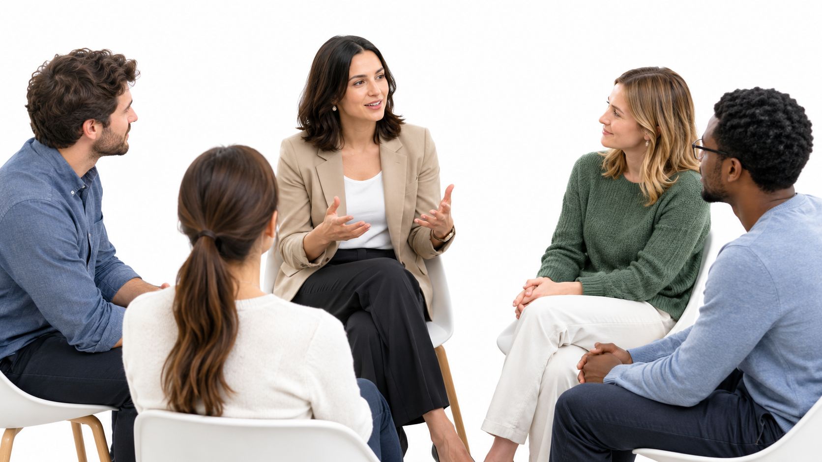 A diverse group of professionals sitting in a circle during a guided team building discussion session.