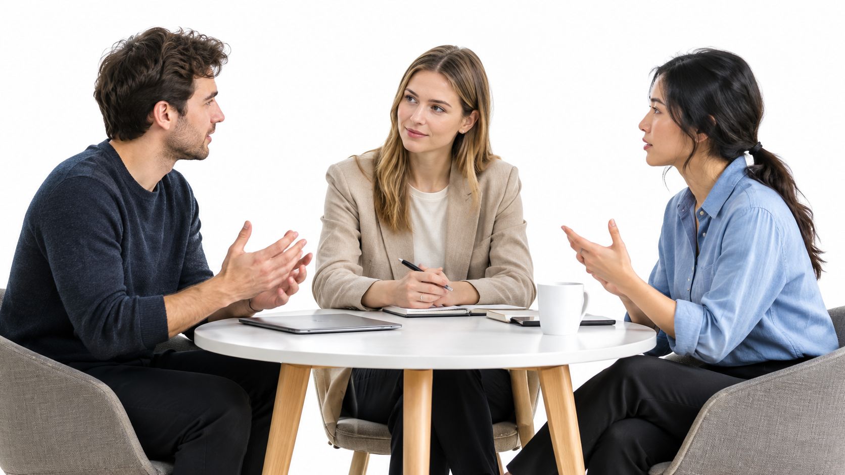 A professional team of three people sitting at a white table discussing business strategies and projects together.